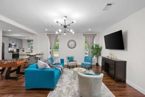 a living room with a blue couch and a table at Gated 2BR Near Med Center NRG MD Anderson DT in Houston