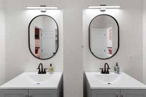 a bathroom with two sinks and two mirrors at Gated 2BR Near Med Center NRG MD Anderson DT in Houston +19 photos