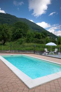 a swimming pool with a mountain in the background at Mountain Lake Endine- Iseo Milly's Home in Bianzano