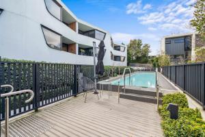 a balcony with a swimming pool and a building at Luxury 3 storey residence in Melbourne