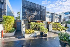 an exterior view of a building with plants at Luxury 3 storey residence in Melbourne