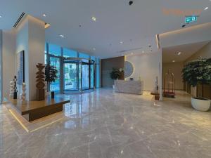 a lobby of a building with plants and a table at Exclusive Home with Private Beach in Dubai