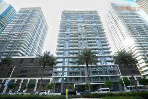 two tall buildings with palm trees in front of them at Exclusive Home with Private Beach in Dubai