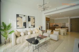 a living room with a white couch and a table at Exclusive Home with Private Beach in Dubai