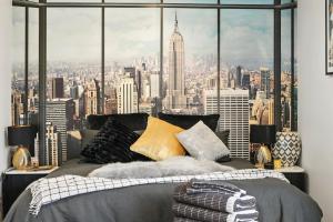 Seven Mile BeachBeachside Studio Retreat的一间卧室设有大窗户,享有城市景观