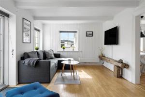 a living room with a couch and a table at 70240-Ulfborg-Vesterhavsgade-12 in Thorsminde