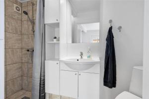 a white bathroom with a sink and a shower at 70240-Ulfborg-Vesterhavsgade-12 in Thorsminde +22 photos