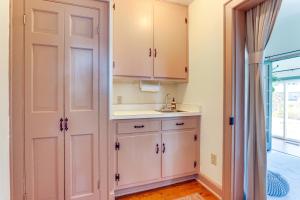 a kitchen with white cabinets and a sink at Walkable Location Historic Home in Charles Town! in Charles Town +22 photos