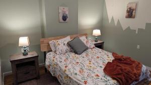 a bedroom with a bed with two night stands and two lamps at Relaxing Rustic Oasis II, Unit B - 6 minute walk to Downtown! Cyclists Welcome! in Cumberland