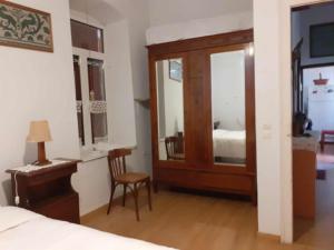 a bedroom with a bed and a desk and a chair at LILIA in Poros