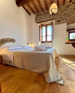 a bedroom with a large bed with towels on it at Torre della Soara - Medieval Tower in the Umbrian Countryside in Città di Castello