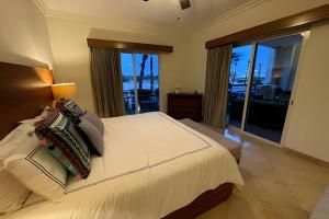 a bedroom with a bed with a view of the ocean at Puerta Cabos Village in Cabo San Lucas +19 photos
