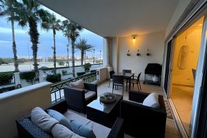 a living room with a balcony with palm trees at Puerta Cabos Village in Cabo San Lucas