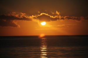 a sunset over the ocean with the sun in the sky at Zanzibar House Boutique Hotel in Matemwe +55 photos