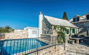 a house with a swimming pool next to a building at Humac Vero Apartments in Donji Humac