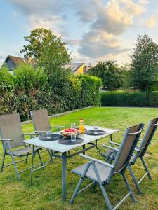 a table and chairs on the grass in a yard at Ferienhaus Zingel in Eckernförde