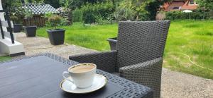 a cup of coffee sitting on a table at Apartment im Grünen bis 7 Personen in Buchholz in der Nordheide +2 photos