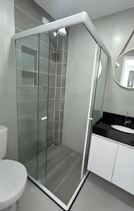 a bathroom with a shower and a toilet and a sink at Villa do Porto Resindece in Porto De Galinhas
