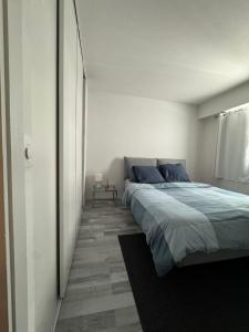 a bedroom with a large bed in a white room at Eden butler monaco in Beausoleil