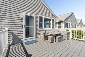 a deck with chairs and a table on a house at Coastal Bliss in Rye