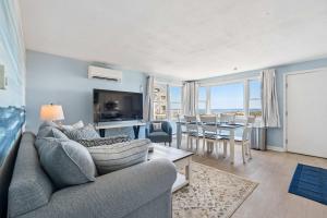 a living room with a couch and a table at Coastal Bliss in Rye +15 photos