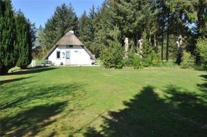 a large yard with a white house in the background at 10168-Ulfborg-Baekbyvej-55 in Øby +19 photos