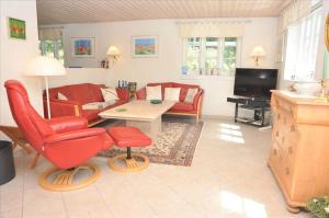 a living room with red chairs and a couch at 10825-Ulfborg-Vester-Mosevej-35 in Øby