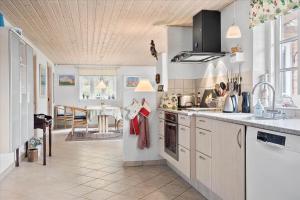 a kitchen with a sink and a stove top oven at 10825-Ulfborg-Vester-Mosevej-35 in Øby