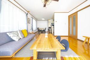 a living room with a couch and a table at Soyo in Tsumagoi