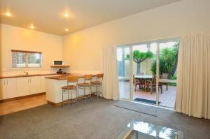 a kitchen and dining room with a view of a patio at Ocean Beach Motor Lodge in Gisborne
