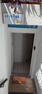 an entrance to a hallway with a sign on the floor at Apartma Dessa in Portorož