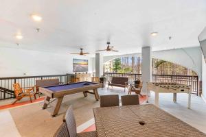 a room with a ping pong table and chairs at Bowen Village 2118B in Charleston