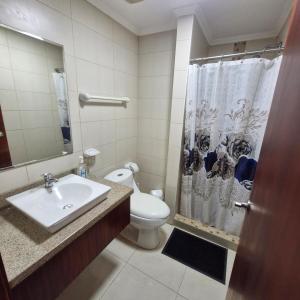a bathroom with a toilet and a shower curtain at Vista al faro Habitacion doble in Guayaquil