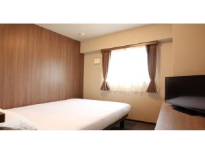 a small room with a bed and a window at Smile Hotel Hakata Ekimae - Vacation STAY 64019v in Fukuoka