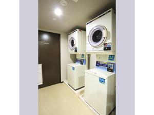 a laundry room with a washer and dryer at Smile Hotel Hakata Ekimae - Vacation STAY 64019v in Fukuoka