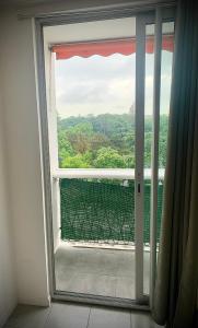 an open window with a view of a balcony at 15D Vinatier Grange Blanche Bron Essarts in Bron