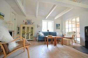a living room with a blue couch and a table at 30358-Ulfborg-Bynkevej-367 in Vang