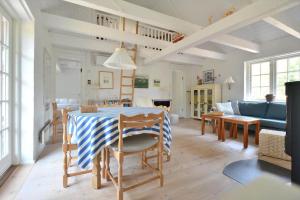 a kitchen and living room with a table and chairs at 30358-Ulfborg-Bynkevej-367 in Vang