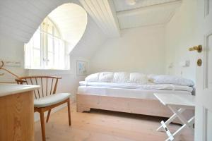 a bedroom with a bed and a table and a chair at 30358-Ulfborg-Bynkevej-367 in Vang