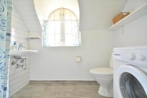 a bathroom with a toilet and a sink and a window at 30358-Ulfborg-Bynkevej-367 in Vang +15 photos