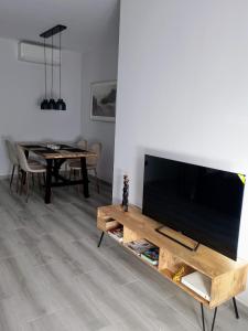 a living room with a television and a table at Light and spacious apartment in the heart of San Fernando, Cádiz in San Fernando