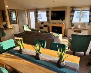 a living room with a couch and a table at Meadows 90 - Southview Holiday Park Skegness in Skegness