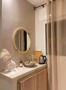 a bathroom with a mirror and a bowl on a counter at Cozy nest bedroom - family only in Tangier