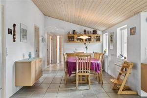 a kitchen and dining room with a table and chairs at 10704-Ulfborg-Gaffelbjergvej-49 in Øhuse