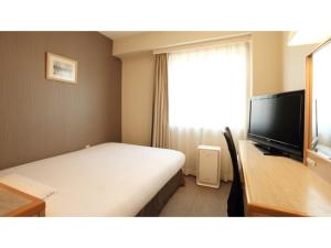a hotel room with a bed and a television at Smile Hotel Shimonoseki - Vacation STAY 12508v in Shimonoseki