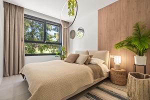 a bedroom with a large bed and a window at Evergreen Exclusive in Mijas Costa +20 photos