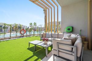 a living room with a couch and a green lawn at Evergreen Exclusive in Mijas Costa