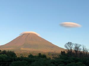 an ufo flying over a mountain in the sky at Ferreiro do Cabeço House in Bandeiras