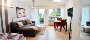 a living room with a couch and a table at Studio apartment with balcony in Ingolstadt