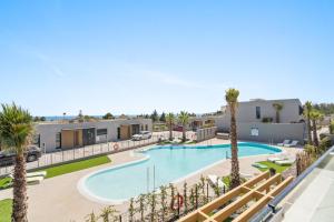 a view of the pool at a resort with palm trees at Evergreen Exclusive in Mijas Costa